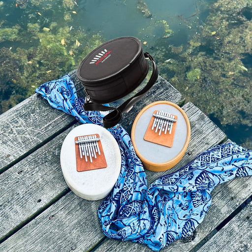 Hokema sansula deluxe and Renaissance kalimbas with a bag by the water | weplaywelltogether