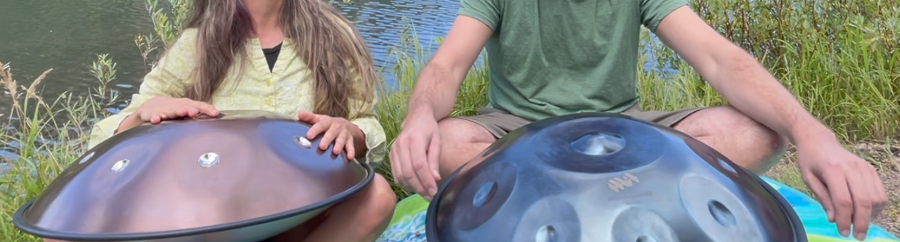 Brother and sister playing Spacedrum handpans together beside Mary's Lake in Estes Park, Colorado