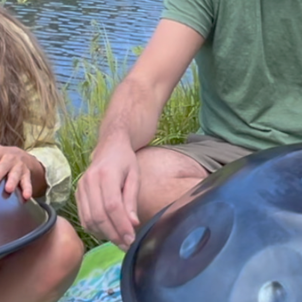 Brother and sister playing Spacedrum handpans together beside Mary's Lake in Estes Park, Colorado