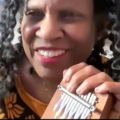 Robbi K rocks the beat on her kalimbas