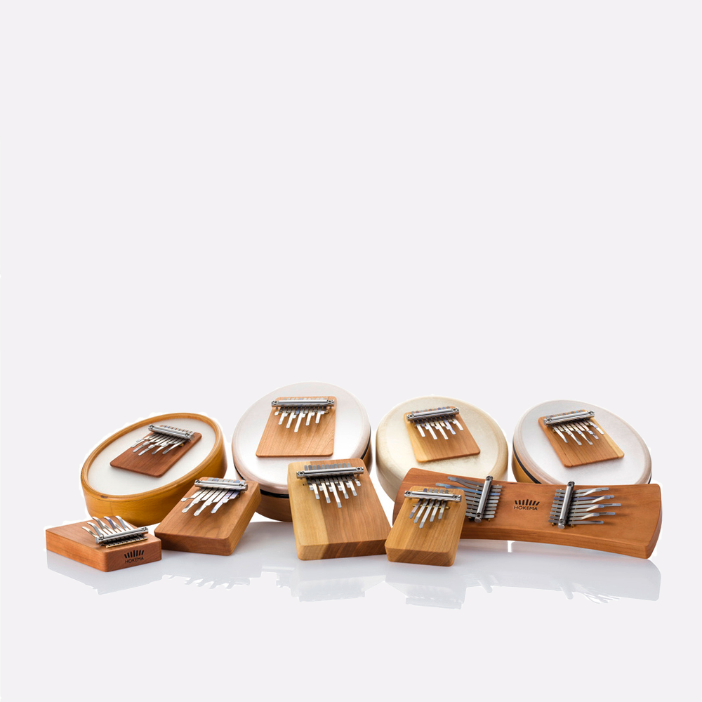 Different sizes and types of Hokema Kalimbas. Kalimbas are made of a block of cherrywood with different numbers stainless steel tines. From 5 tines to 17 tines. Each model comes in its own default tuning. Sansulas which have our Kalimba block mounted on a drum frame. Available in different materials and different number of tines. | weplaywelltogether