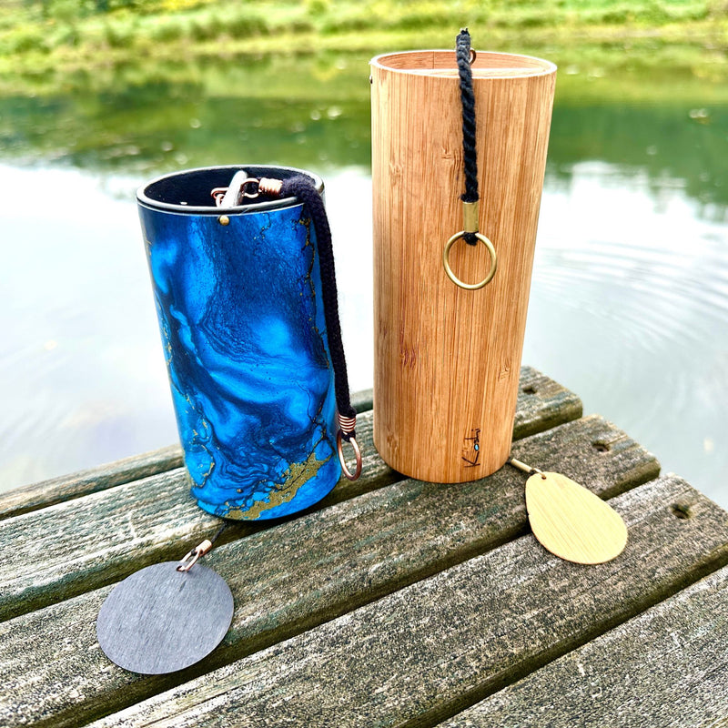 Set of a Zaphir Chime Blue and Koshi Chime Aqua  sitting on a wooden dock in front of a lake | weplaywelltogether 