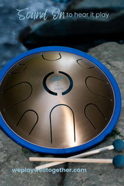 Zenko elemental metal tongue drum in Aqua tuning with mallets by the water | weplaywelltogether