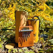 Hokema B5 kalimba with yellow Zaphir and Koshi Aria chimes in nature  | weplaywelltogether
