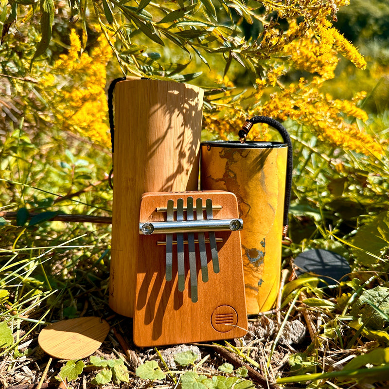Hokema B5 kalimba with yellow Zaphir and Koshi Aria chimes in nature  | weplaywelltogether