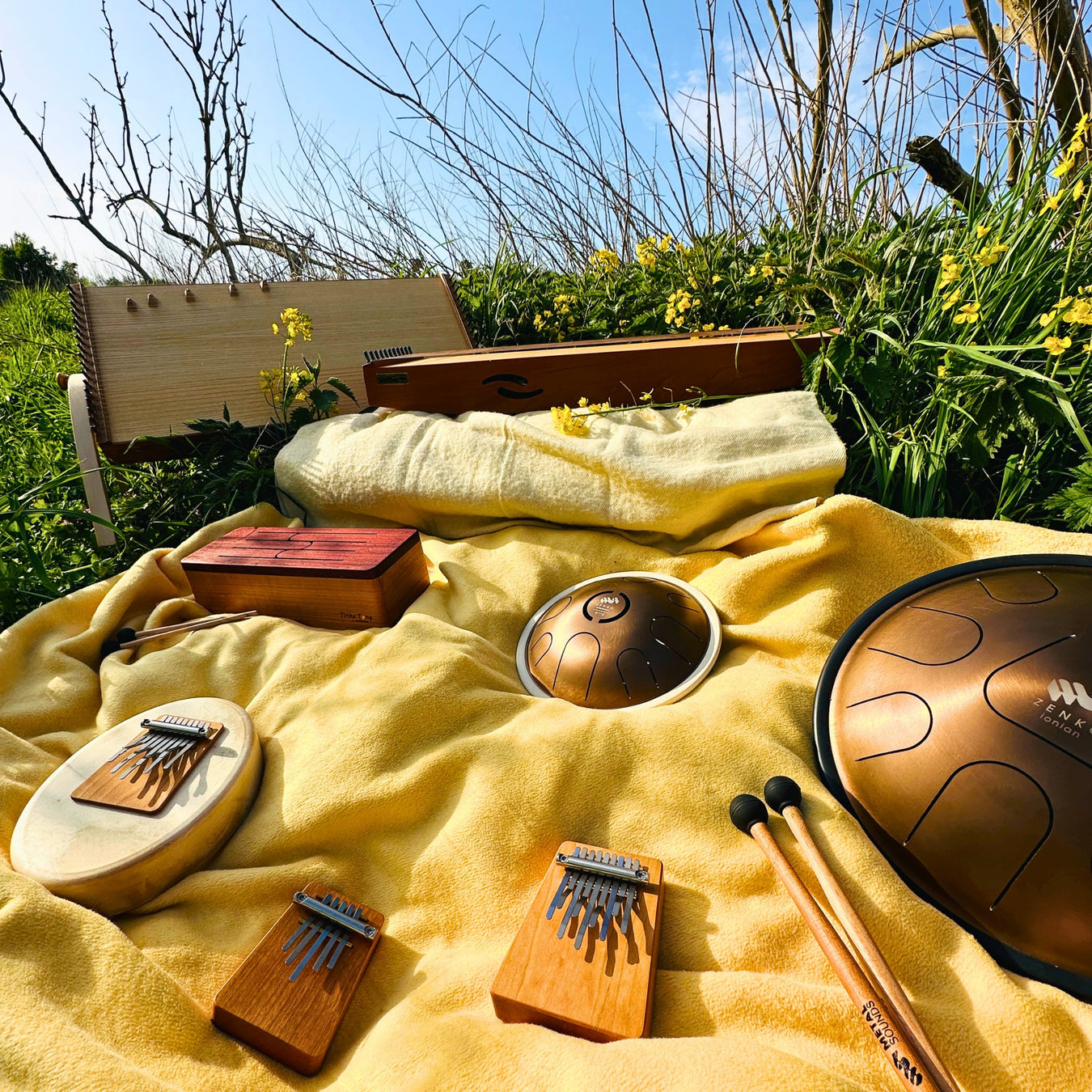 feeltone monochords, Hokema Sansula Basic, B0 and B5 kalimbas, feeltone Tinka Tong wooden tongue drum and Zenko metal tongue drum in nature | weplaywelltogether