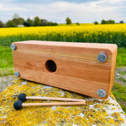 feetone Tinka Tong tongue drum in Air tuning with mallets by the field | weplaywelltogether