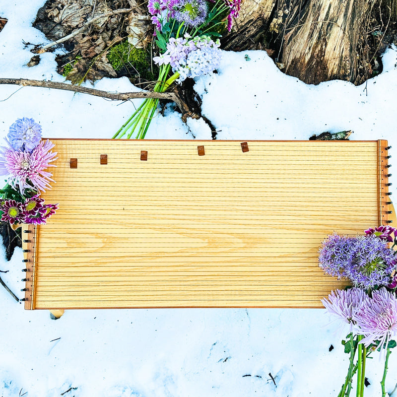 feeltone Monolina in snow with flowers | weplaywelltogether