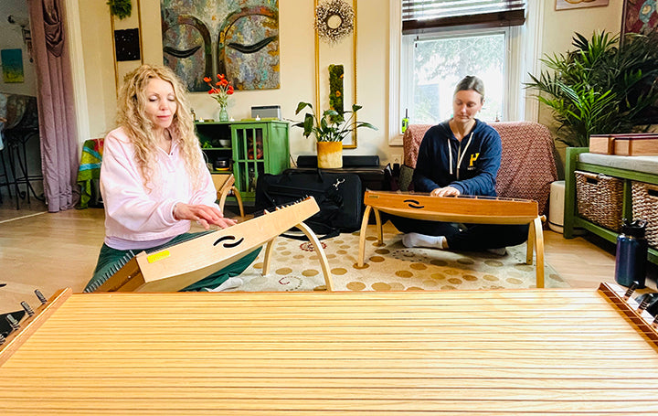 Two women playing feetone monochords | weplaywelltogether