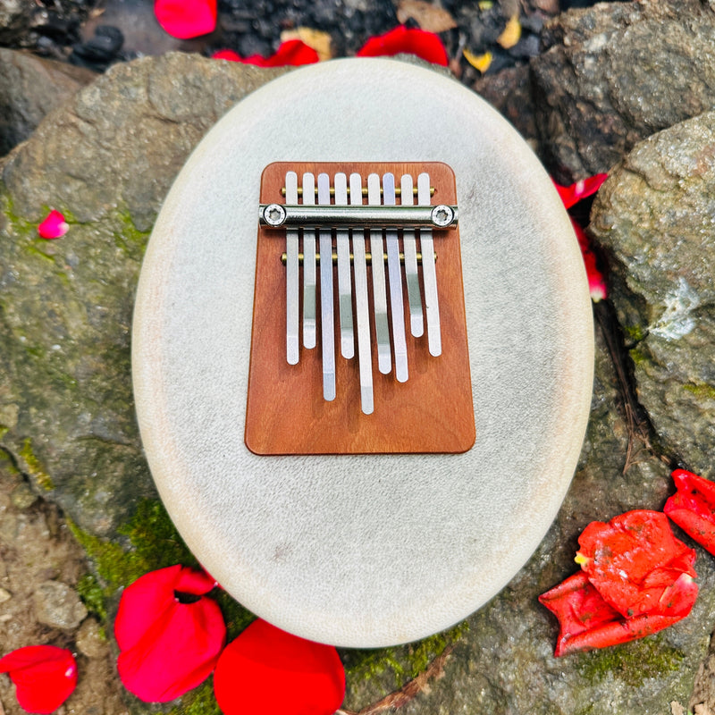 Hokema sansula deluxe kalimba on a rock | weplaywelltogether