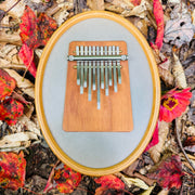 Hokema Sansula Melody kalimba has a mounted drum head and 11 tines on a wooden block. | weplaywelltogether