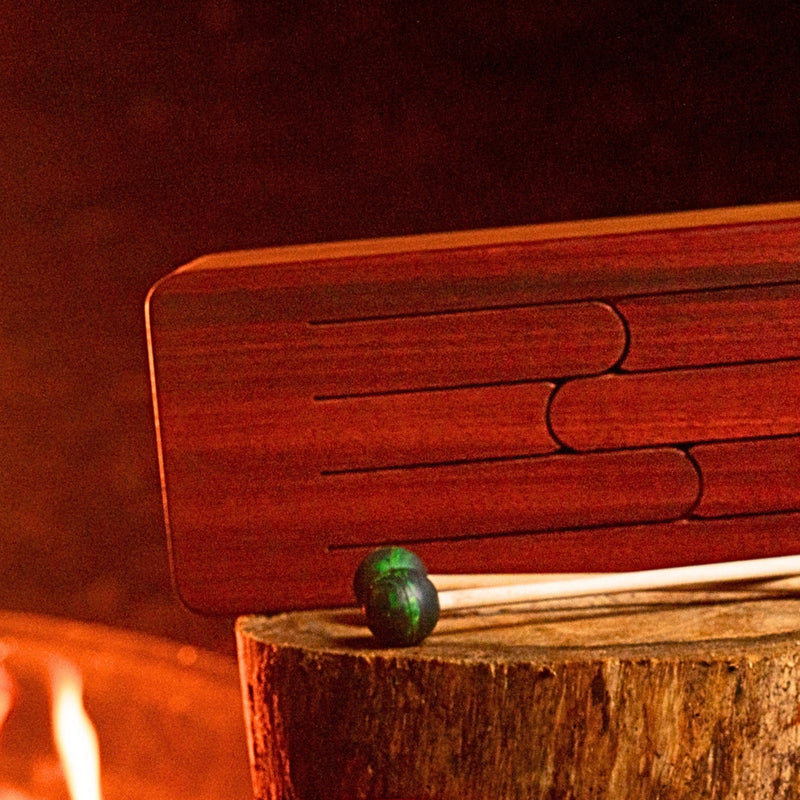 feetone Tinka Tong tongue drum in Fire tuning with mallets by the fire | weplaywelltogether