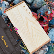 feeltone Monolina Monochord and carrying case by the rocks | weplaywelltogether