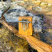 Hokema B5 Kalimba in Aqua tuning  on a branch in a creek | We Play Well Together 