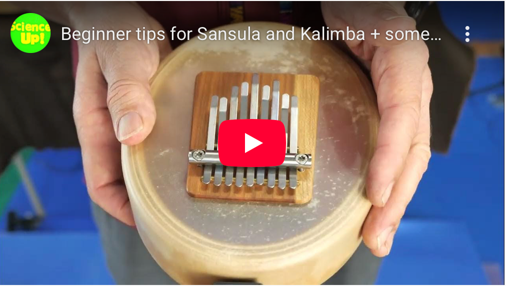 A person holding Hokema Sansula Deluxe kalimba | weplaywelltogether