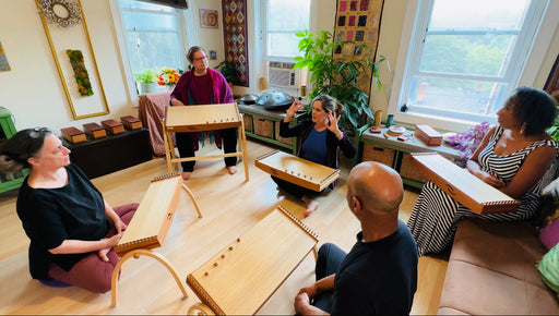 group of people sitting in circle with their feeltone monochords | weplaywelltogether