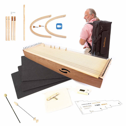 feeltone monolina monochord with mallets, tuner, legs with extensions and a man carrying the monochord in a backpack | weplaywelltogether