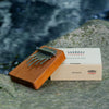 Hokema Kalimba B9 tuned to Koshi Aqua tuning in front of a waterfall | Weplaywelltogether