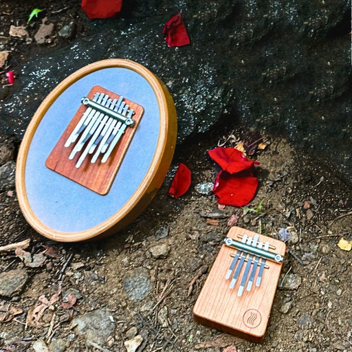 Hokema Sansula Renaissance and B5 Ignis kalimba on ground | weplaywelltogether