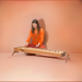 A woman playing concert monochord | weplaywelltogether